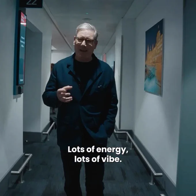 keir stinker in a corridor saying "lots of energy, lots of vibe"