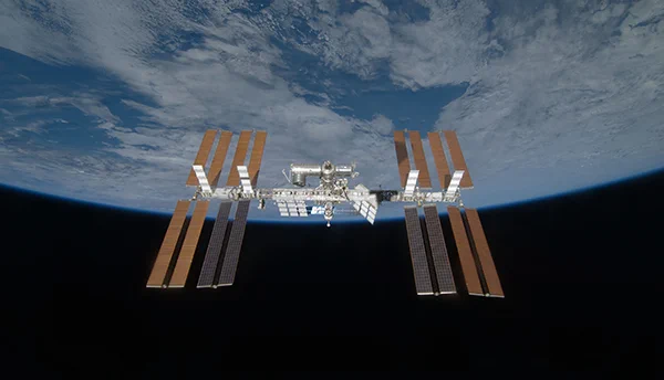 View of the International Space Station with the curve of the Earth in the background. 