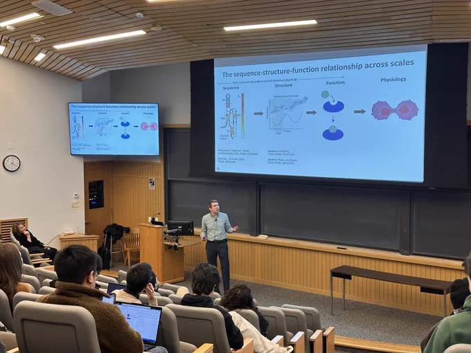 Andrew Savinov at front of lecture hall