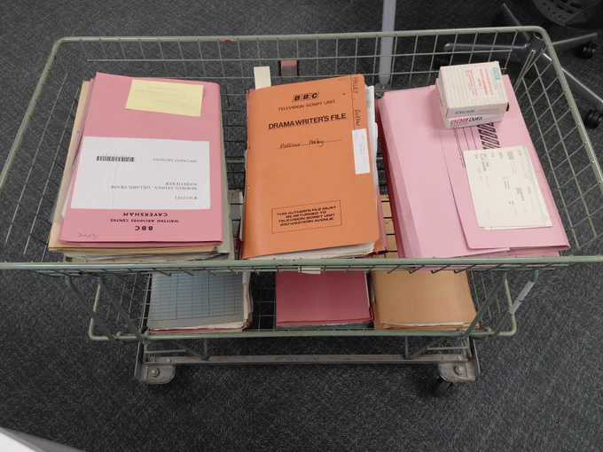 A trolley loaded with archive document folders.