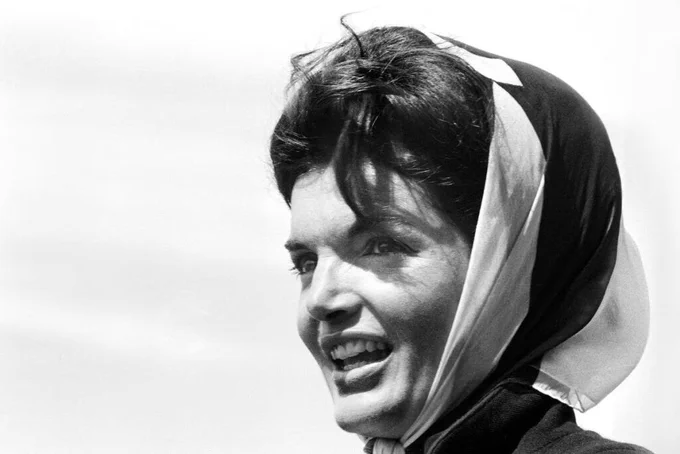  The standout accessory was a silk headscarf tied neatly under her chin, one of Jackie O’s most recognizable street-style signatures.