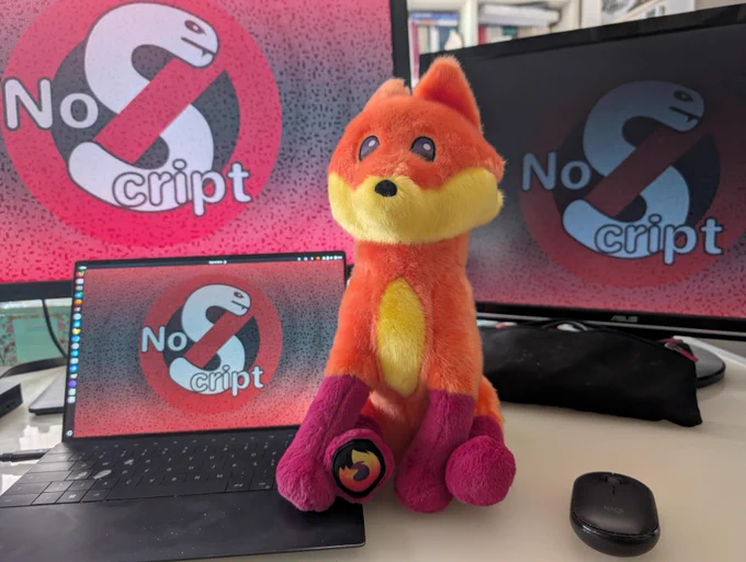 A picture of a brand new Firefox plushie sitting on ma1's laptop.