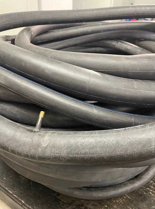 Photo of bicycle inner tubes that have been patched/repaired.