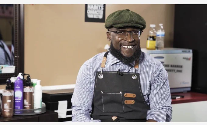 Photo of Rodney Taylor sitting in his barber shop
