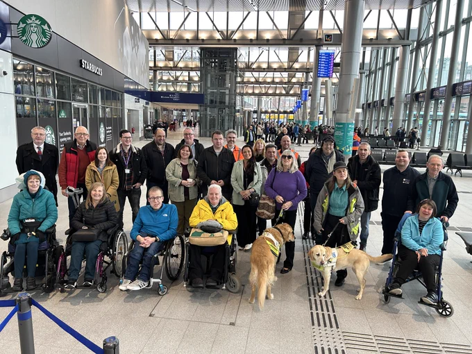 Image shows Imtac members and others gathered for a group photo during a site visit to Grand Central Station in Belfast.