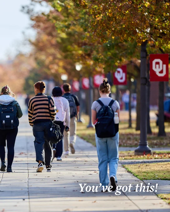 Students walking on a tree-lined campus pathway with University of Oklahoma banners displayed. The words "You've got this!" are overlaid on the image.