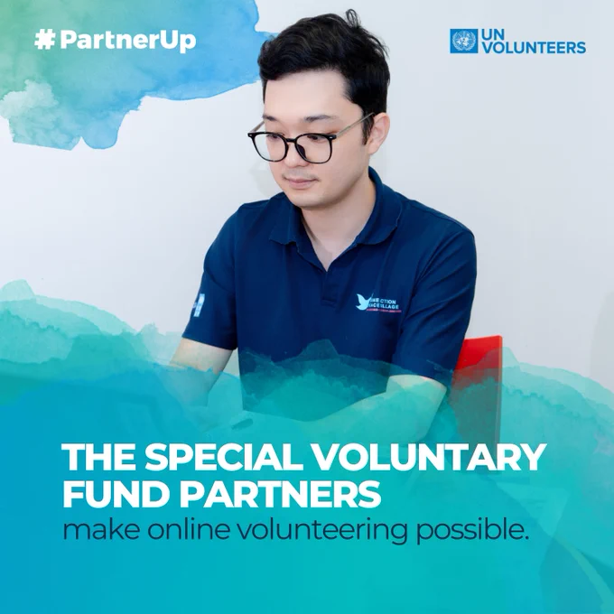 A man wearing glasses and a navy-blue polo shirt sits at a desk working on a laptop. The image features a teal watercolor-style overlay with the text “The Special Voluntary Fund Partners make online volunteering possible.” The UN Volunteers logo appears in the top right corner, and the hashtag #PartnerUp is displayed in the top left.
