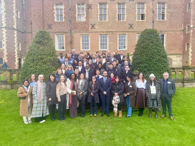 University of Cambridge's Data Science with Machine Learning & AI Career Accelerator learners standing on the grass in front of Madingley Hall.