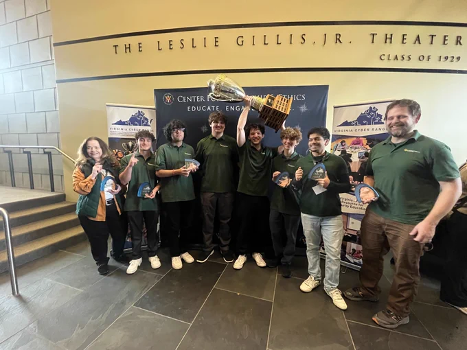 George Mason University winners pose with plaques and a large championship trophy at Cyber Fusion 2026.