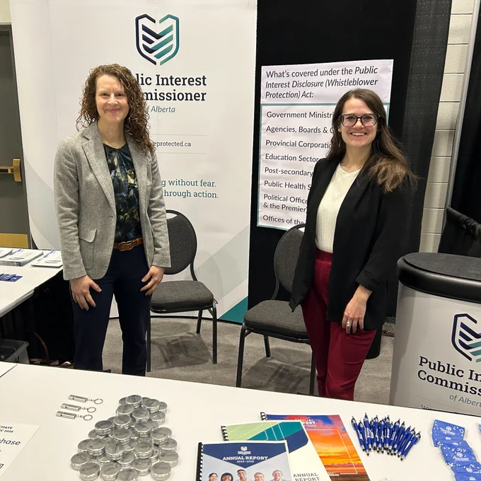 Representatives from the Public Interest Commissioner's office at their trade show booth at the Calgary Teachers' Convention of Alberta. 