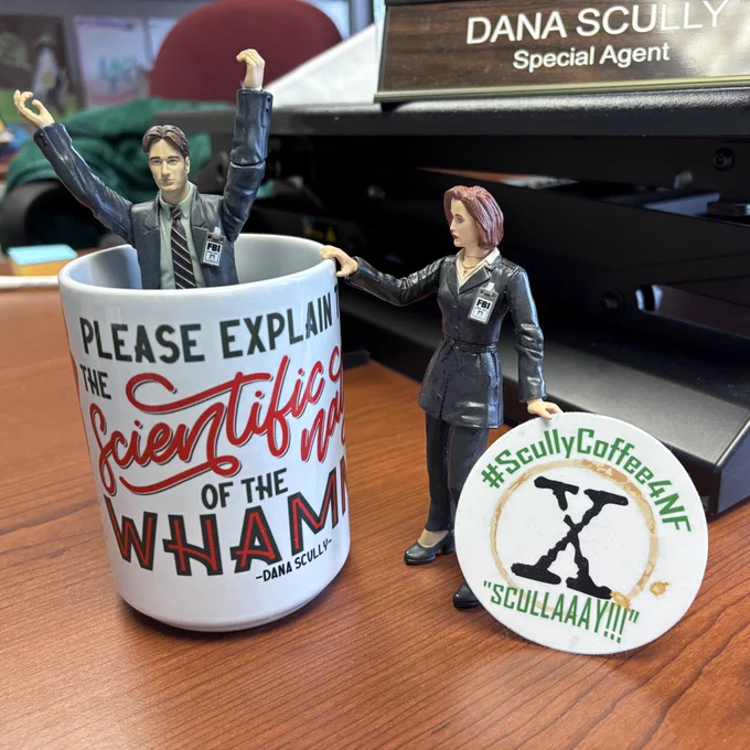 Mulder action figure in a scully coffee mug. Scully action figure next to him.
