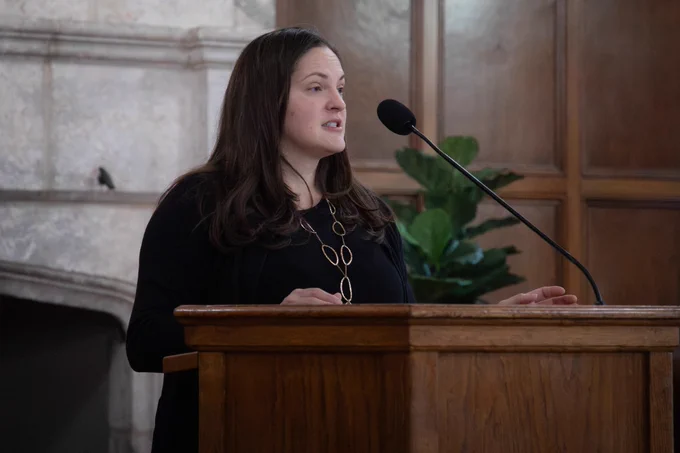 Virginia Lewis, an associate professor in the Department of Classics and the event coordinator of the symposium, speaks from the podium.