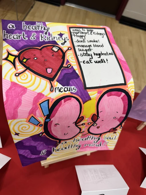 Brightly colored poster with a cartoonish anthropomorphic heart and kidneys dancing together with big smiles.  A caption says “a healthy heart and kidneys mean a healthy soul and a healthy mind.”