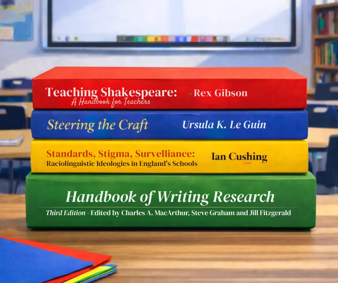 A stack of four books showing the CPD titles recommended by Debra Myhill sits on a classroom desk, with a whiteboard and blurred classroom background behind it.
