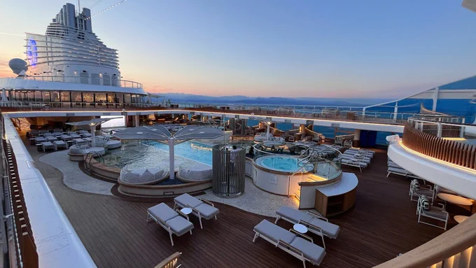 Oceania Cruises Oceania Vista Top Deck Pool Deck with sunset in the background