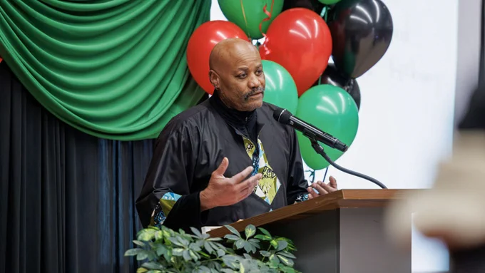 Kofi Acree, director of the John Henrik Clarke Africana Library and curator of Africana Collections for the Division of Rare and Manuscript Collections, welcomes guests to the community celebration. Picture by Alexandra Bayer.