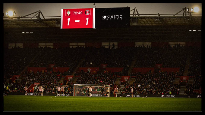 A photograph from St Mary's Stadium, where Southampton FC are 1 -1 with Charlton Athletic FC. On the stadium's screens we see the score alongside Kinetic Games branding, which also can be seen on the boards around the field.