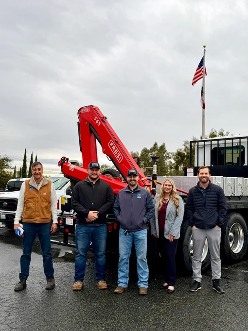 Photo of Weights & Measures staff standing in a parking lot.