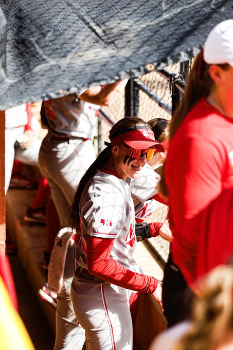 A Nebraska player smiling with her tongue sticking out