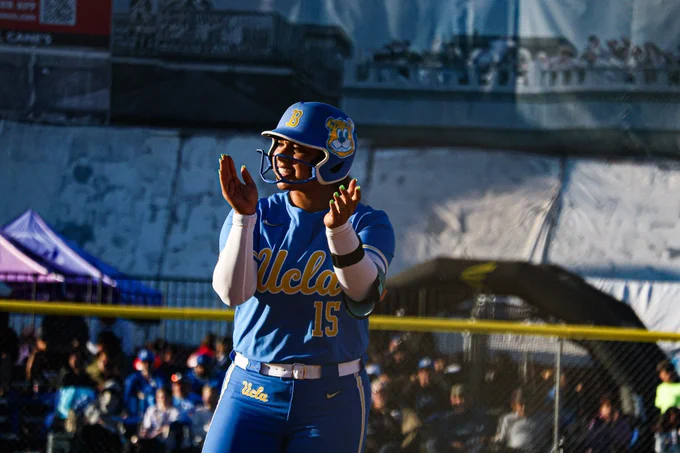A UCLA player clapping after getting on base