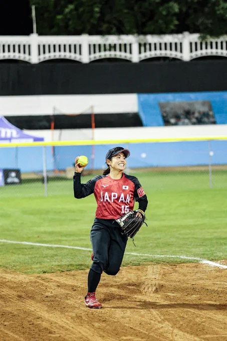 A Team Japan player running in and smiling after catching a ball in LF
