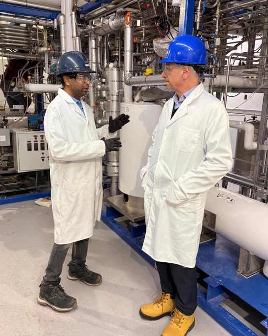 Anil Jhawar and Don Fusco discussing the NGP Pilot Plant, standing in front of the a section of the Zeton-fabricated plant.