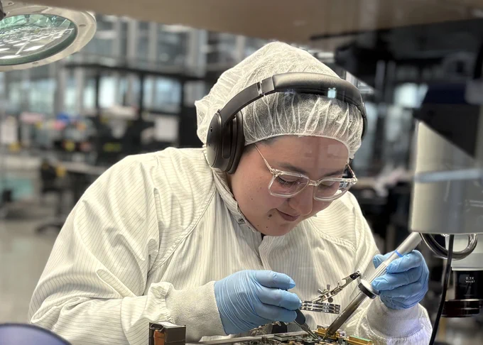 Technician soldering in cleanroom