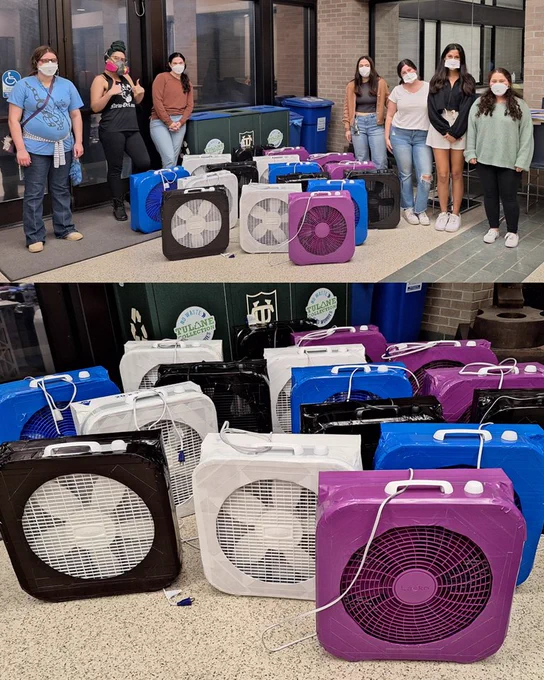 Students and community members posing with air purifiers