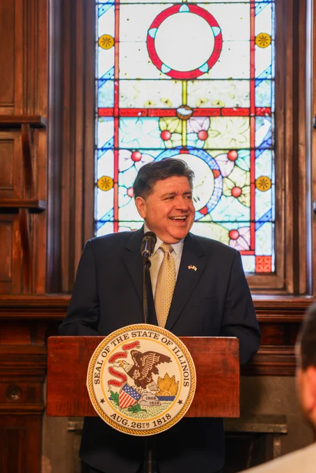Governor Pritzker speaks at the podium.