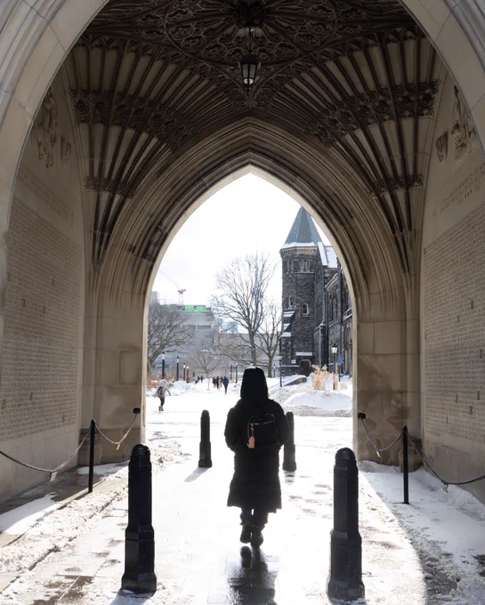 A student walking through Soldiers' Tower