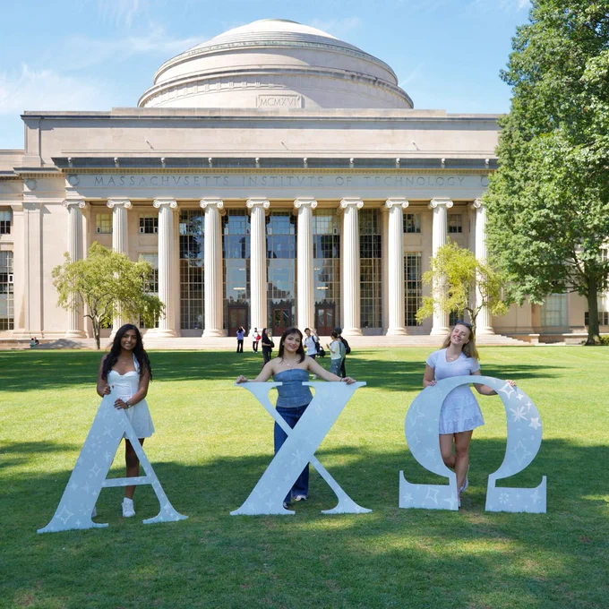 Lucy Kanias poses on Killian Court with the Greek letters representing her sorority.