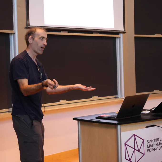 Francis Nimmo, Professor of Earth and Planetary Sciences at UC Santa Cruz, speaking behind a podium at the Simons Laufer Mathematical Sciences Institute at UC Berkeley.