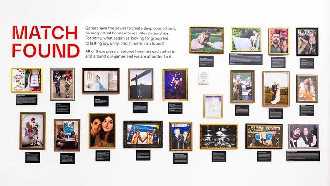 Image shows a white gallery wall filled with framed photographs of couples, weddings, engagements, and cosplay, each with a story placard beneath.
Large red text on the left reads:
“MATCH FOUND”
Paragraph text on the wall reads:
“Games have the power to create deep connections, turning virtual bonds into real-life relationships. For some, what began as ‘looking for group’ led to lasting joy, unity, and a true ‘match found’.”
“All of these players featured here met each other in and around our games and we are all better for it.”