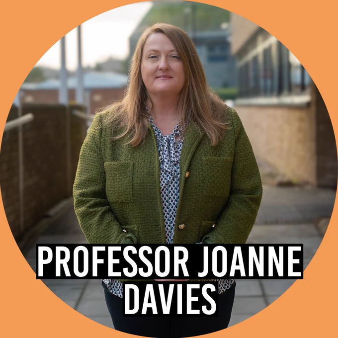 Professor Joanne Davies poses in front of building.