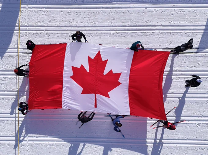 Giant Canadian flag held by skiers at the Gatineau Loppet.