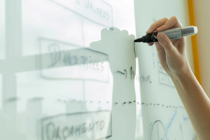 A hand drawing on a whiteboard with a black marker