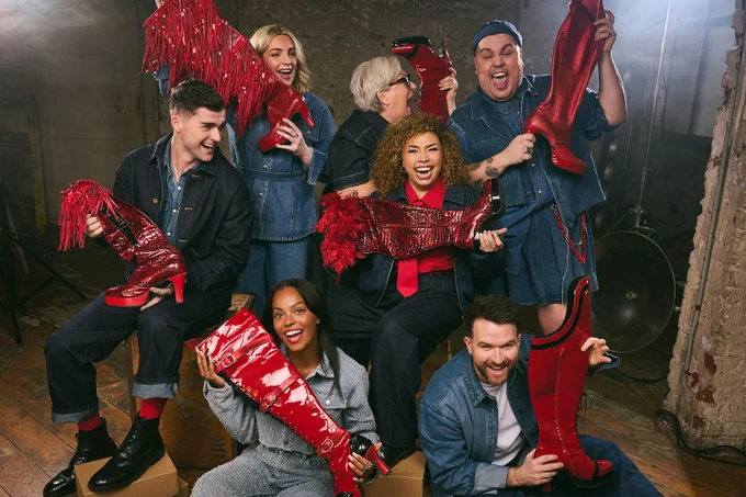 A photo showing a group of performers holding red shoes 