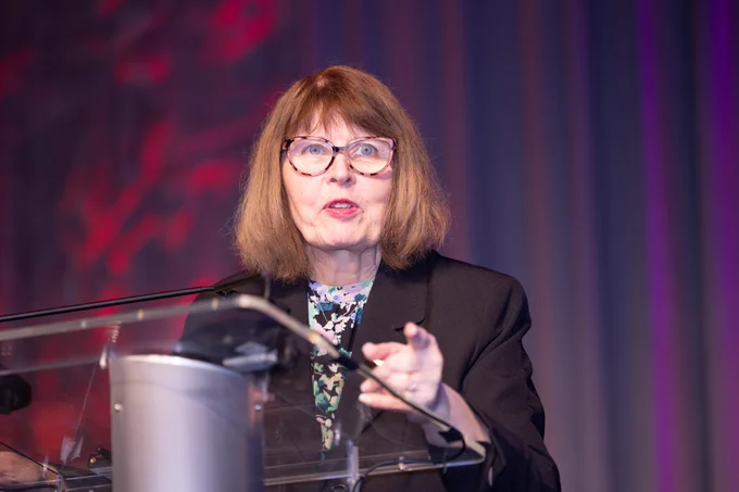 Dr. Kathleen Gura speaking at a podium.