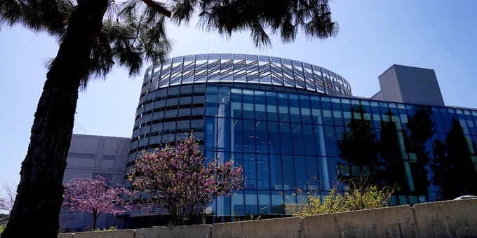 Fresno State Library is surrounded by campus foliage and a bright blue sky.