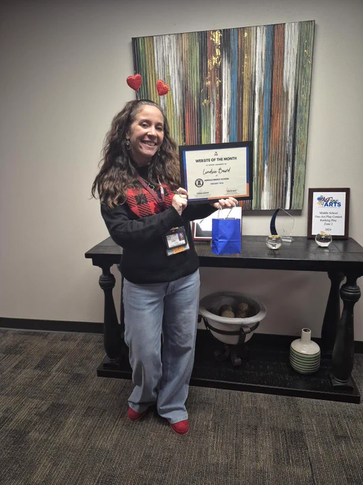Lindsie Baird holding up her certificate.