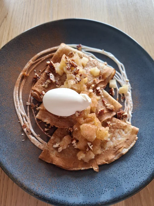 Blue plate with 3 crepes, apple compot, toasted walnuts, cinnamon and creme fraiche