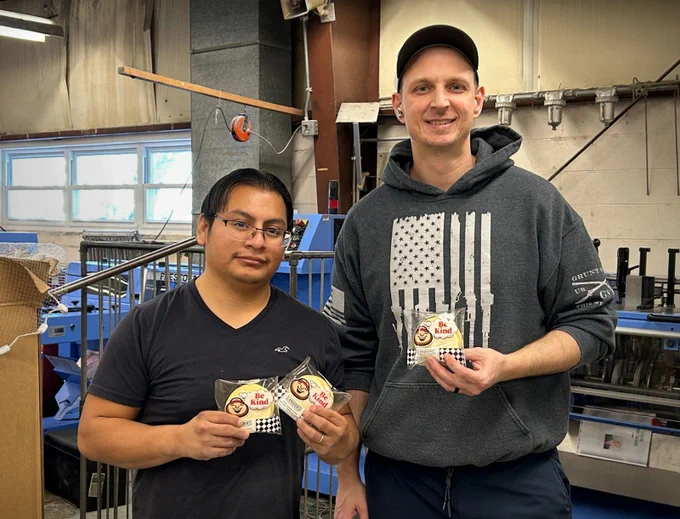 UniPrint bindery operators pose with #BuckeyeLove cookies from CHRR at The Ohio State University. 