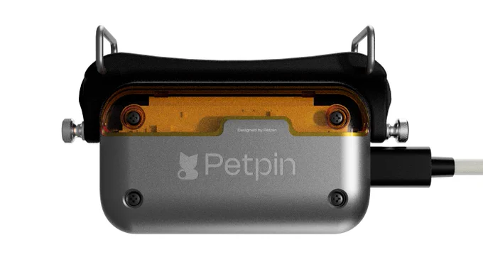Petpin V0 production-ready collar-mounted wearable, back view with mounting hardware and USB-C charger.