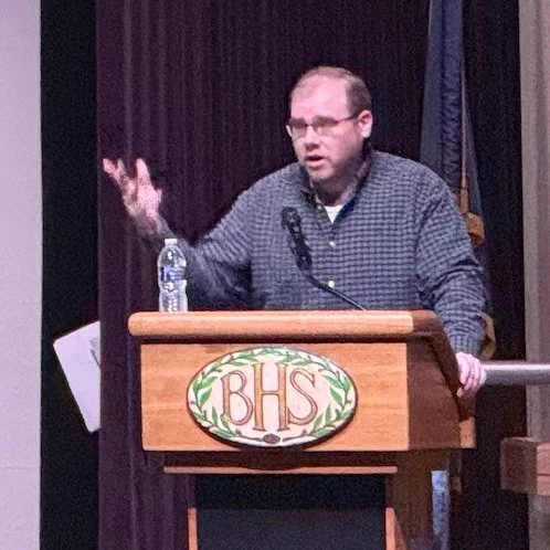 Brandon Grainger speaking at a podium