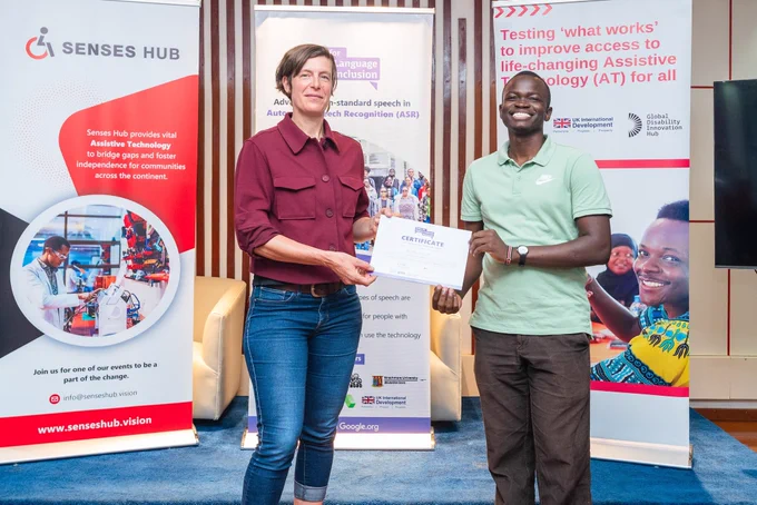 Brian, a member of Sauti Yetu receiving a certificate of completion after the makerthon
