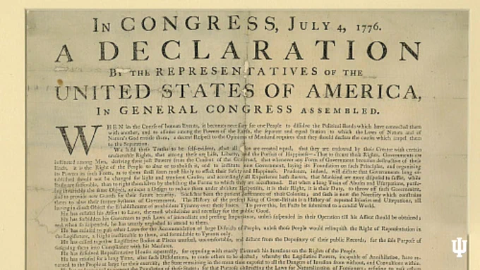 The image shows the text of the Declaration of Independence, titled "In Congress, July 4, 1776: A Declaration by the Representatives of the United States of America, in General Congress Assembled." The text begins with a reference to the necessity to dissolve political bands and assert independence. The document states grievances against the British Crown, emphasizing the colonies' desire for freedom.