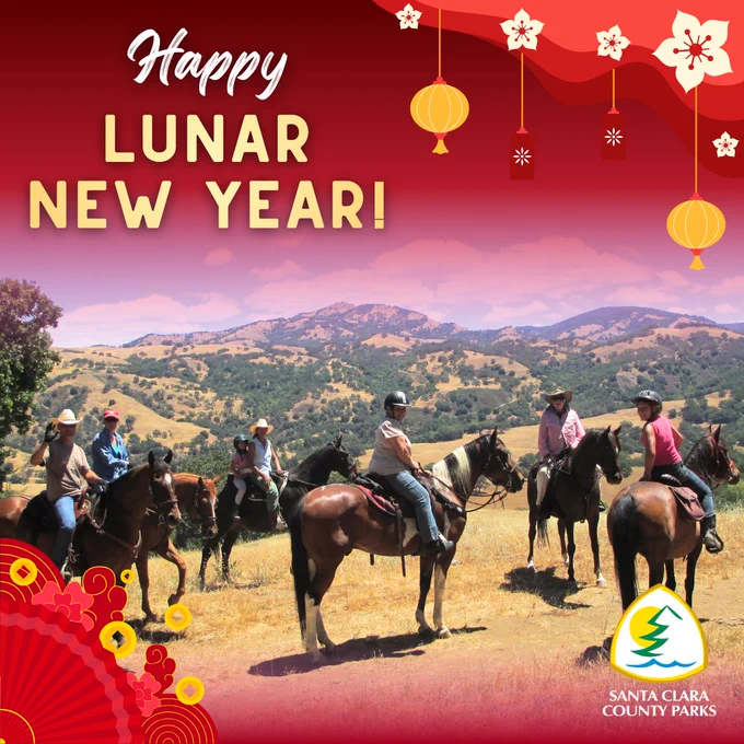 The image shows a group of individuals riding horses on a grassy landscape with rolling hills in the background. The foreground features festive decorations and text that reads "Happy Lunar New Year!" The Santa Clara County Parks logo is displayed in the bottom right corner.