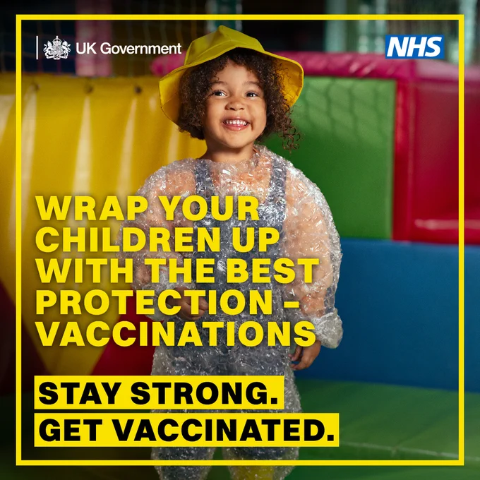 Child wearing a yellow hat and wrapped in bubble wrap, symbolizing protection, with NHS and UK Government logos promoting vaccination.
