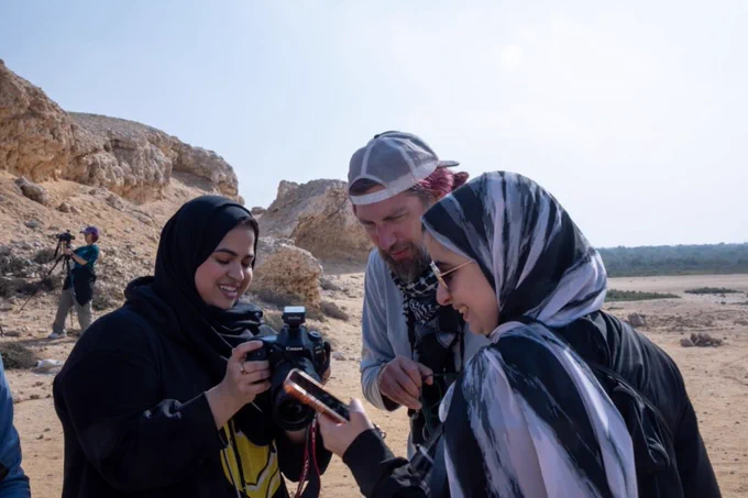 Students and faculty using a camera in the desert