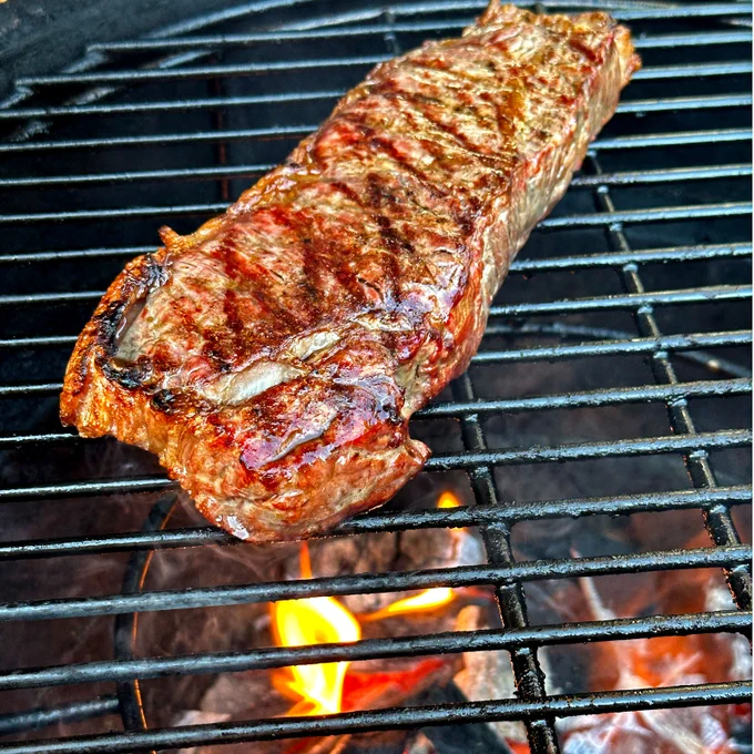 New York Strip Steak over fire coals.